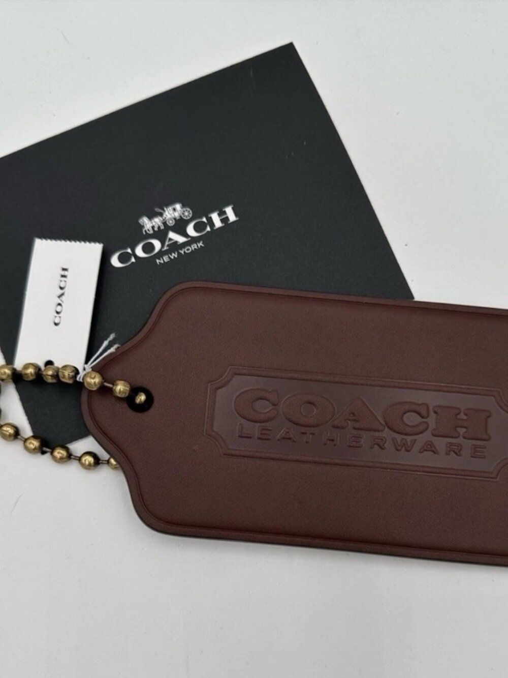 Coach XL Hangtag Bag Charm in a dark brown leather color